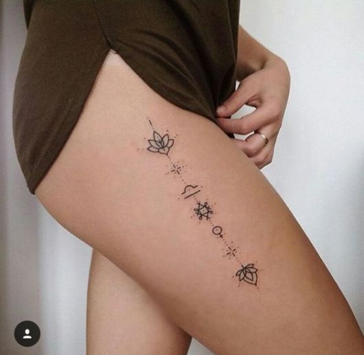 as mais lindas tatuagens na coxa feminina linha vertical floral